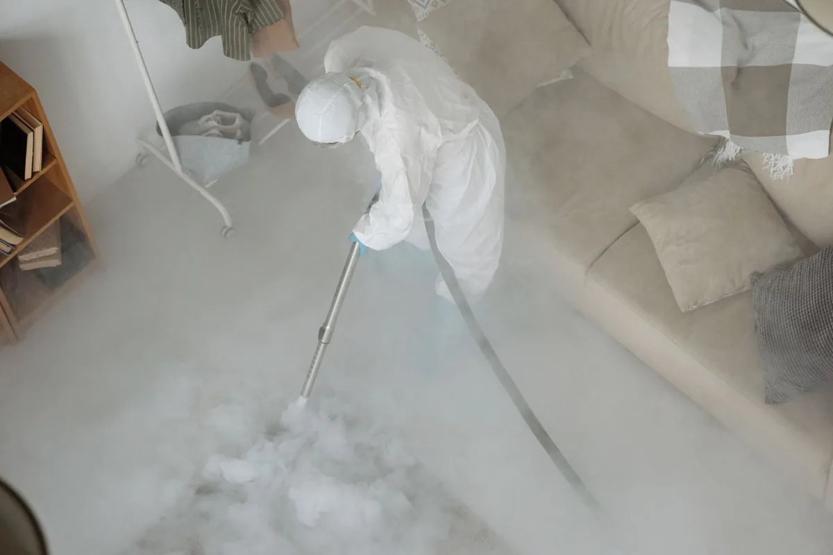 Biohazard cleanup technician in protective equipment, Karnes City, TX